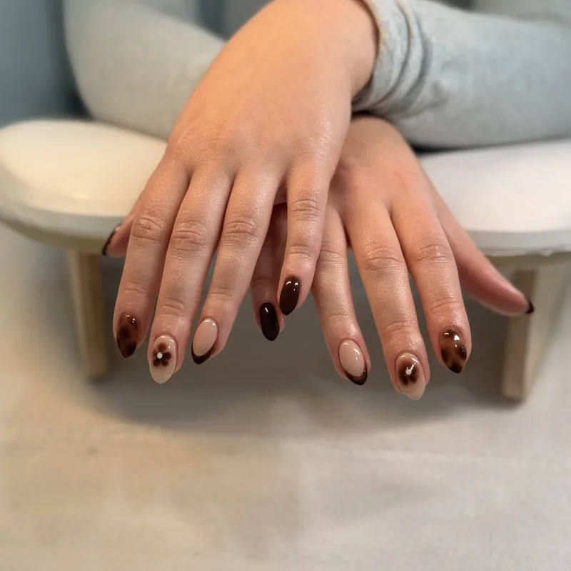 Short almond nails in a dark chocolate brown.