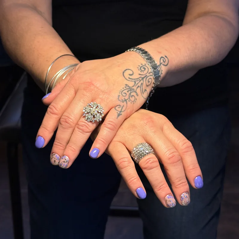Lavender and periwinkle nails with glitter accent nails.