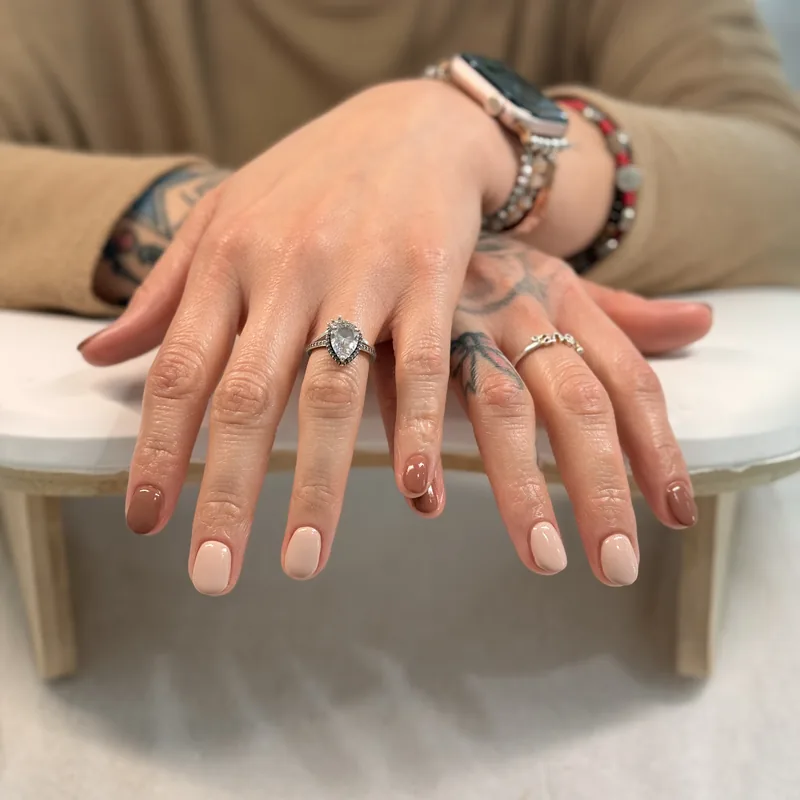 Warm nude almond nails with a soft glossy finish.